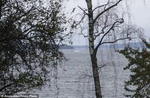 In this amateur photo provided by Sweden's armed forces and distributed by the TT News Agency on Sunday, Oct. 19, 2014, a partially submerged object is visible in the water at center, in the Stockholm archipelago, Sweden. The Swedish military said Sunday it had made three credible sightings of foreign undersea activity in its waters during the past few days amid reports of a suspected Russian intrusion in the area. (AP Photo/Swedish Armed Forces via TT News Agency) SWEDEN OUT